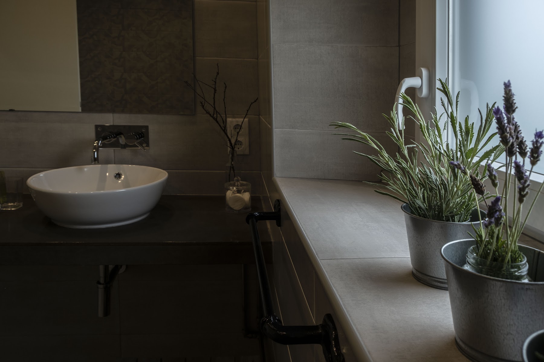 Modern bathroom sink and tiled surfaces at Casa da Quinta